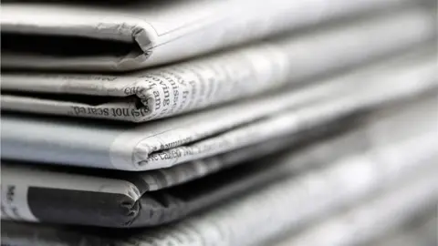 Getty Images Stack of newspapers