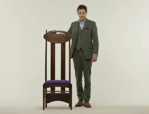 Artist Lachlan Goudie with one of Charles Rennie Mackintosh's iconic chairs