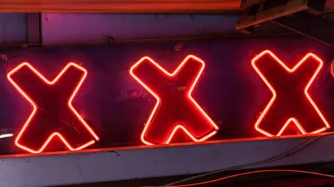 Getty Images A stock image of a neon sign reading XXX