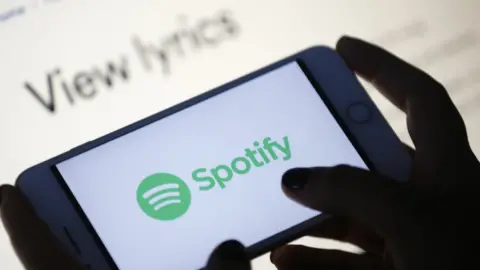 Getty Images The Spotify logo on a phone