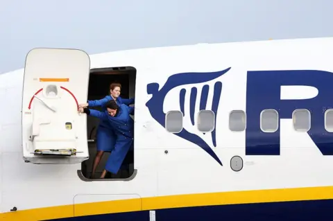 Getty Images Ryanair flight attendants close the airplane door of a Boeing 737-800 at the Altenburg-Nobitz airport, eastern Germany 01 March 2007