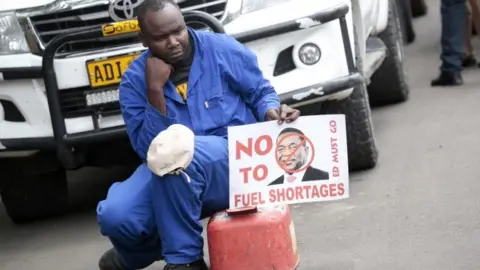 EPA A protester with a fuel container, due to the continuing fuel crisis,as Movement For Democratic Change (MDC) Alliance party members gather in the Africa Unity Square, in Harare, Zimbabwe, 29 November 2018, to protest against the current economic situation facing the country.