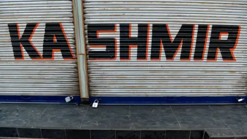 Getty Images A closed shop is pictured during curfew in Srinagar on August 7, 2019.