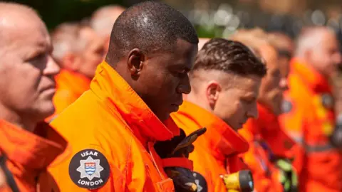 AFP/Getty Images Emergency services marked the minute's silence in the capital