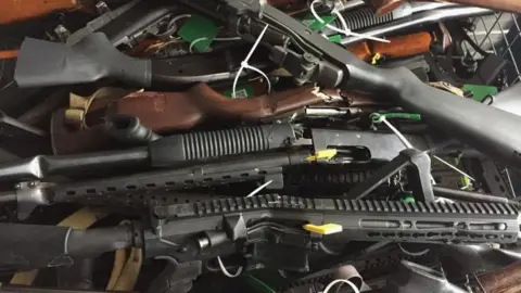 Getty Images In this handout image provided by New Zealand Police, collected firearms are seen at Riccarton Racecourse on July 13, 2019 in Christchurch, New Zealand