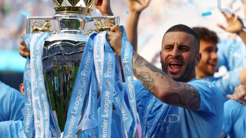 Manchester City's Kyle Walker celebrates with the trophy after winning the Premier League