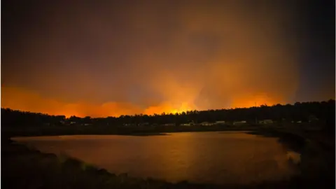Getty Images Fires burning dangerously close can be seen from the Central Highlands Lodge from on January 22, 2019 in Miena, Australia