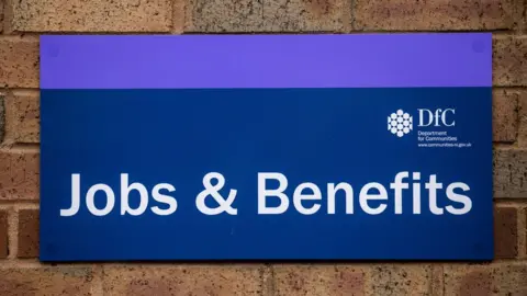 Liam McBurney/PA Jobs and benefits sign