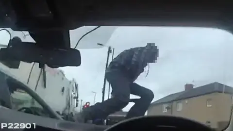 Man climbs over police car