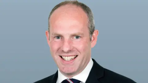 DWP Justin Tomlinson MP