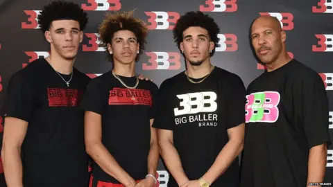 Getty Images LiAngelo Ball (second from right) with brothers LA Lakers player Lonzo Ball (left), LaMelo Ball (second from left) and LaVar Ball (right)