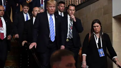 Getty Images Sarah Sanders with President Trump at the G7 summit in Canada on 9 June 2018