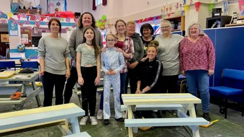 Empics Volunteers are putting their painting skills to good use by giving benches at Islanders Youth and Community Centre in Portland a freshen up.
