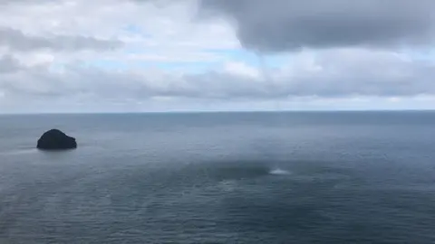 The waterspout next to Gull Rock off the Trebarwith Strand beach