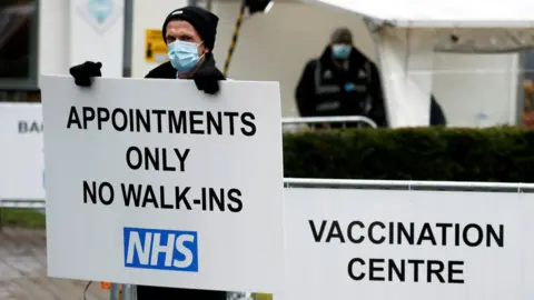 Reuters Man holding sign outside cathedral hub