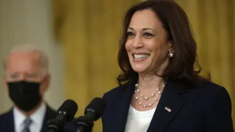 Getty Images U.S. Vice President Kamala Harris (R) speaks as President Joe Biden (L) listens during an event on Senate passage of the Infrastructure Investment and Jobs Act in the East Room of the White House 10 August 2021 in Washington, DC.