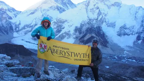 Prof Bryn Hubbard / Aberystwyth University Postgraduate researcher Katie Miles and Prof Bryn Hubbard with the Khumbu glacier is in the background