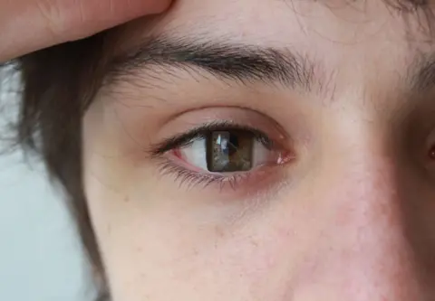 Barnaby Wilkinson A piece of art showing showing a photo of person's eye with a square iris