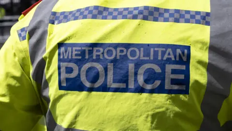 Back of a jacket that reads "Metropolitan Police"