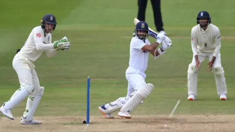 Getty Images India batsman Ajinkya Rahane hits out watched by Jos Buttler during day four of the Second Test Match between England and India at Lord's Cricket Ground on August 15, 2021 in London, England.