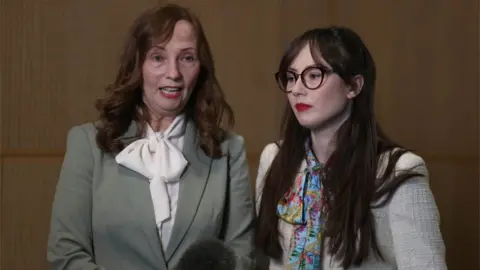 PA Media Carmel Quinn, whose brother John Laverty was shot, with her daughter Mary Kate Quinn