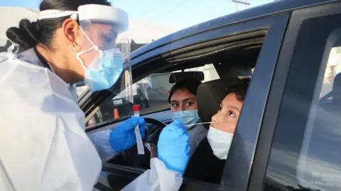 Mario Tama Frontline healthcare worker Joanne Grajeda administers a nasal swab test at a drive-in COVID-19 testing site amid a surge of COVID-19 cases in El Paso on November 13, 2020 in El Paso, Texas.