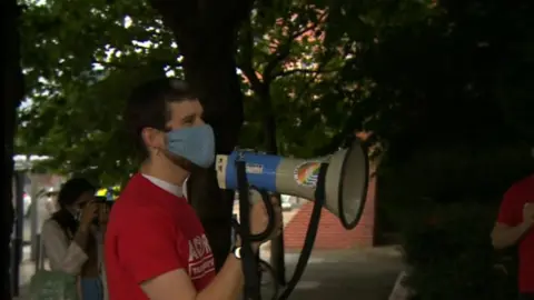 BBC A protester holding a megaphone