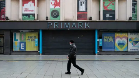 Getty Images Chart showing a man walking by a Primark
