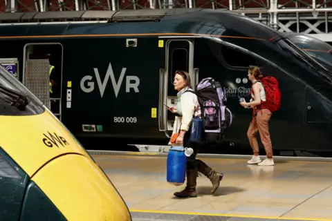 Reuters A traveller with camping equipment walks at Paddington Station