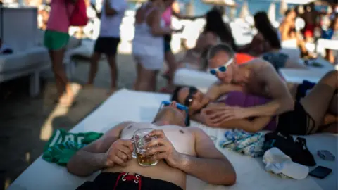 Getty Images People drink in Ibiza