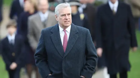 Getty Images Prince Andrew walks alongside his brother to attend the carol service