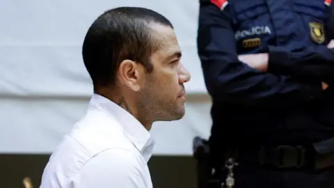 Reuters Brazilian soccer player Dani Alves sits in the dock during his trial for alleged sexual assault at Barcelona's Court in Barcelona, Spain, 05 February 2024.