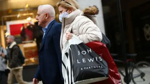 Getty Images Woman carrying John Lewis bag