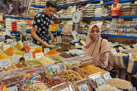 Mahmud Turkia/AFP A woman shops for spices at a market in the old town on 18 June.