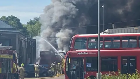 Paul Kirby/BBC Buses on fire at a Potters Bar bus garage