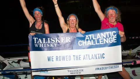 Atlantic Campaigns (L-R) Bird Watts, Claire Allinson and Mo O'Brien after they reached the finish line