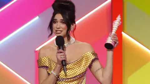 Getty Images Dua Lipa and her Brit Award for best female act