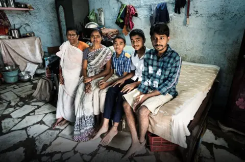 BIMAL tHANKACHAN Y Laxmi (second, left) says a $180 annual handout helps her educate her two sons (third and fourth, left) TREATED PICTURE