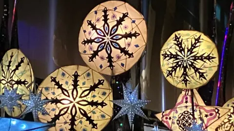 A series of paper lanterns lit up