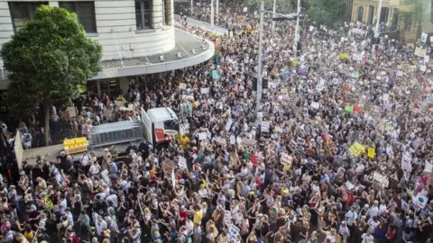 Getty Images Activists rally for climate action at Sydney Town Hall on January 10