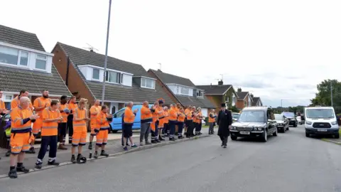 Alex Hannam Refuse collectors line the streets