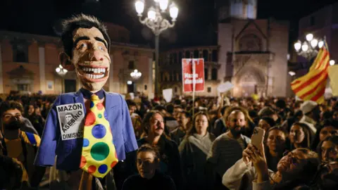 KAI FORSTERLING/EPA-EFE/REX/Shutterstock A person holding a doll showing the President of the Valencian Community Carlos Mazon as thousands of people take part in a protest calling for the resignation of the government of the Valencian region due to the management of floods in the province of Valencia, Valencia, Spain, 09 November 2024.