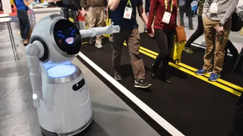 EPA Cruzr service robot greets exhibition goers during CES 2018 at the Las Vegas Convention in Las Vegas on January 12, 2018.