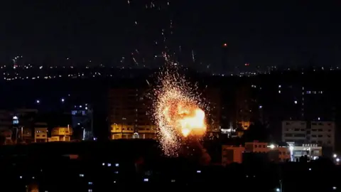 Reuters An explosion is seen in Gaza following an Israeli air strike (2 May 2023)