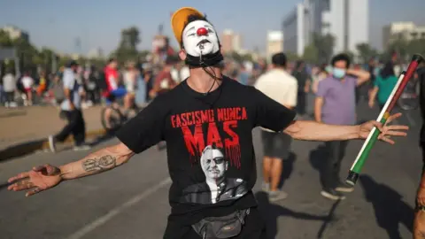 Reuters A man gestures as demonstrators congregate after Lucia Hiriart, the widow of Former Chilean dictator Augusto Pinochet, passed away, in Santiago