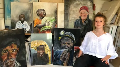 BBC Makenzy Beard, 14, with a selection of her paintings