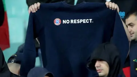 Reuters Bulgarian fans hold up a "No respect" jumper