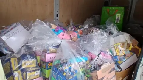 Westmorland and Furness Council Dozens of toys - many boxed - wrapped up in clear plastic bags.