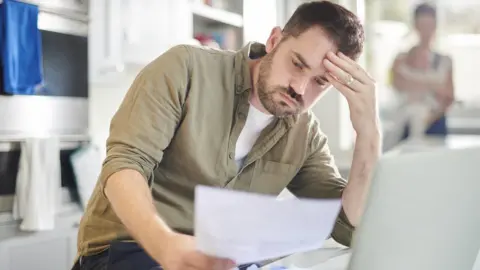 Getty Images Man worried about finances