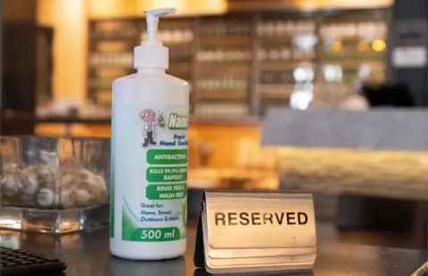 AFP/Getty Images A bottle of hand sanitiser is seen at a restaurant in Wellington on 14 May, 2020.